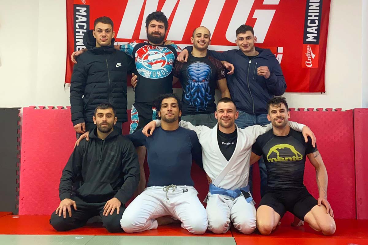 8 guys on tatami posting for picture kneeling